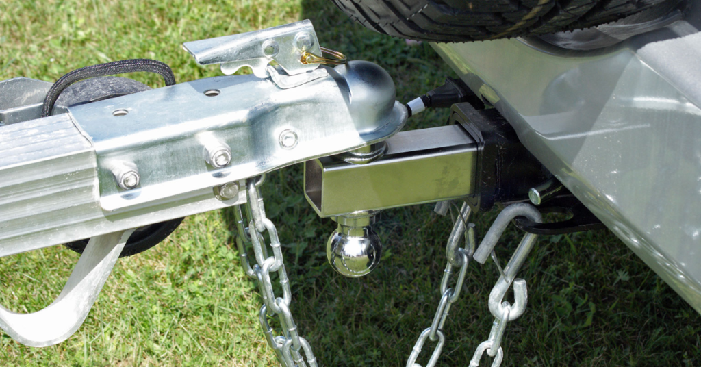 A trailer hitch lock is installed over a ball hitch to prevent trailer theft when not in use. 
