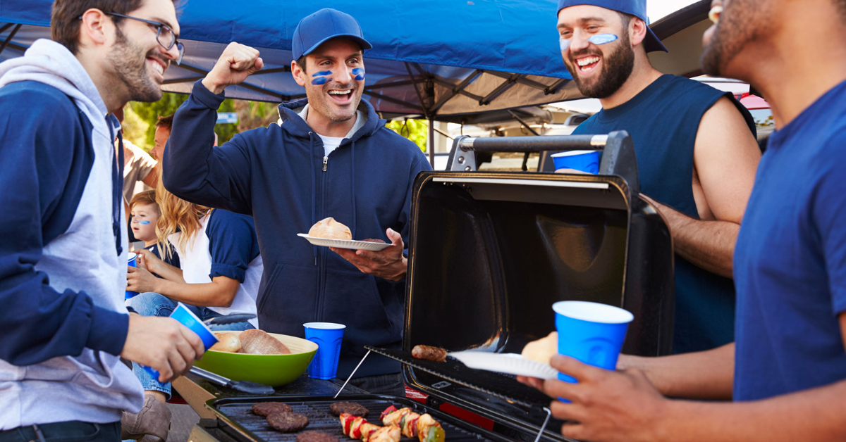 A group of people tailgating before a sports event. 