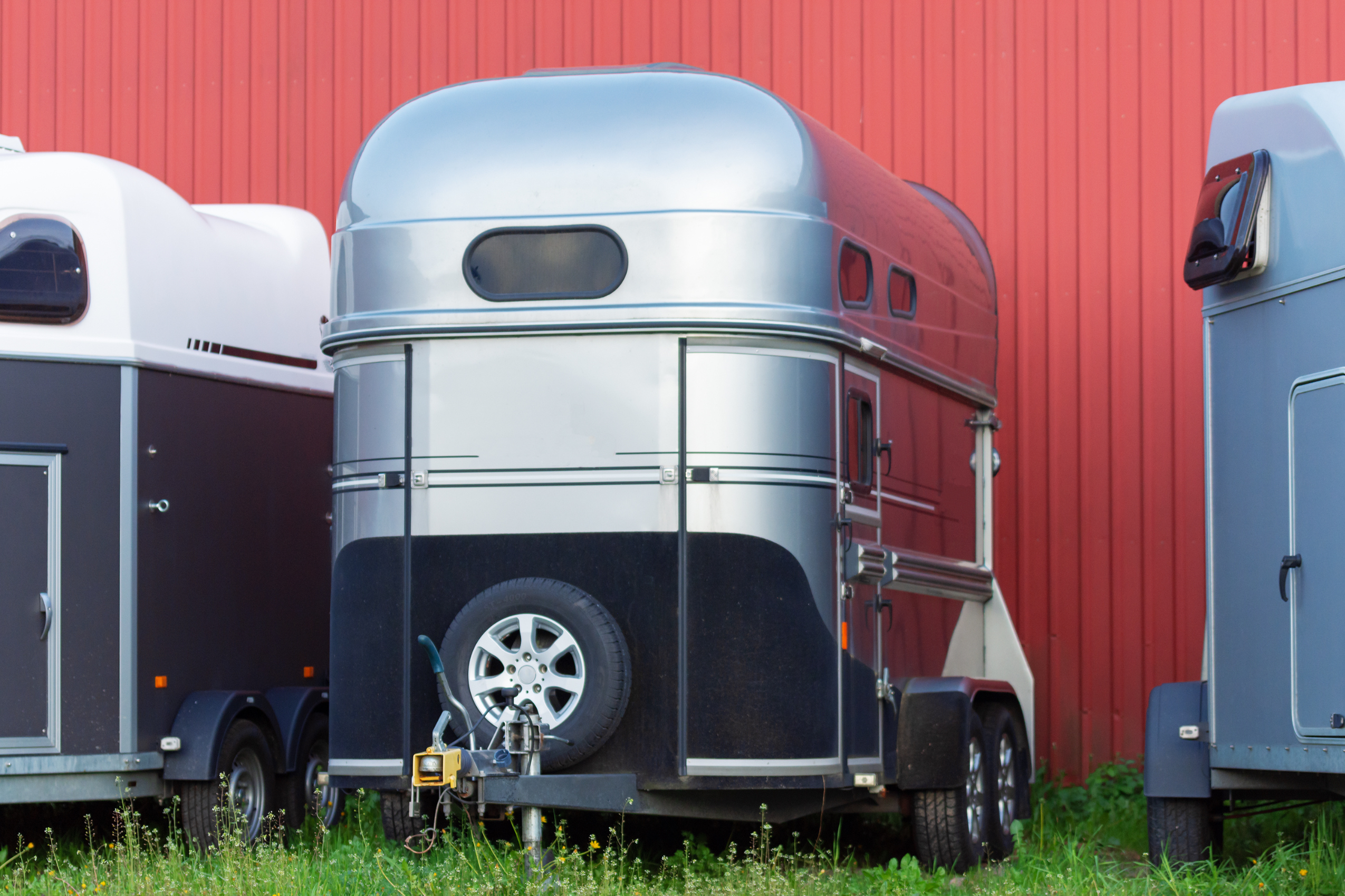 Covered utility trailers sit on an Albuquerque trailer sales lot. 